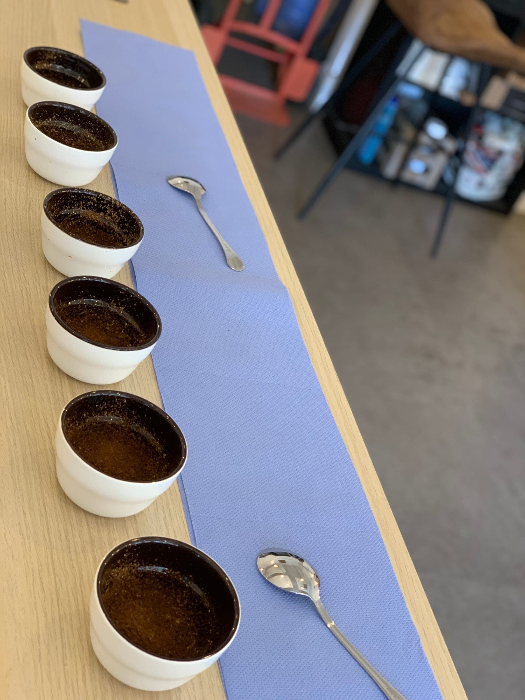 A row of cupping bowls used to taste and quality-check each roast