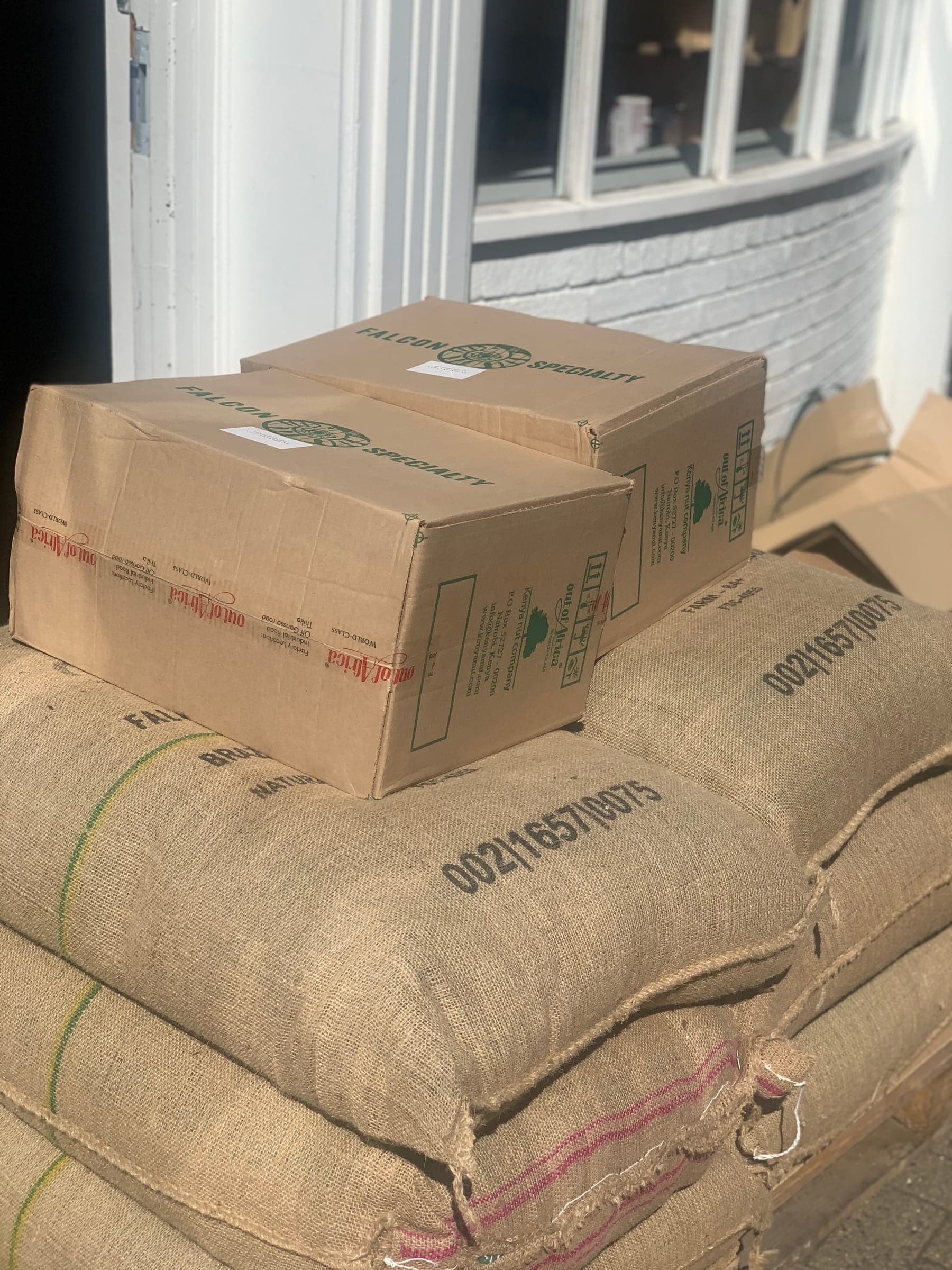 Sacks of green coffee stacked at the roastery, ready to roast