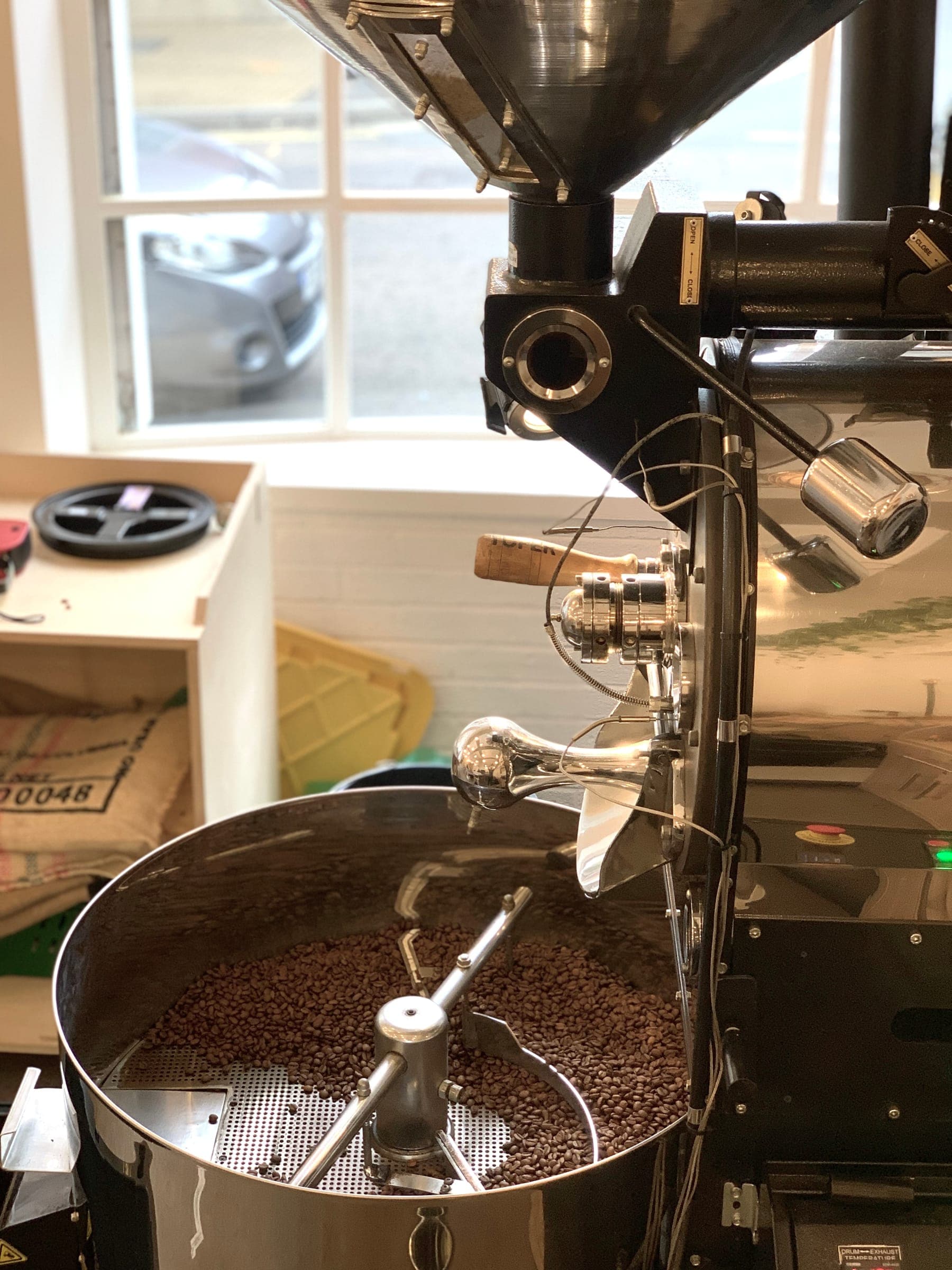 Coffee beans turning in the roaster drum mid-roast